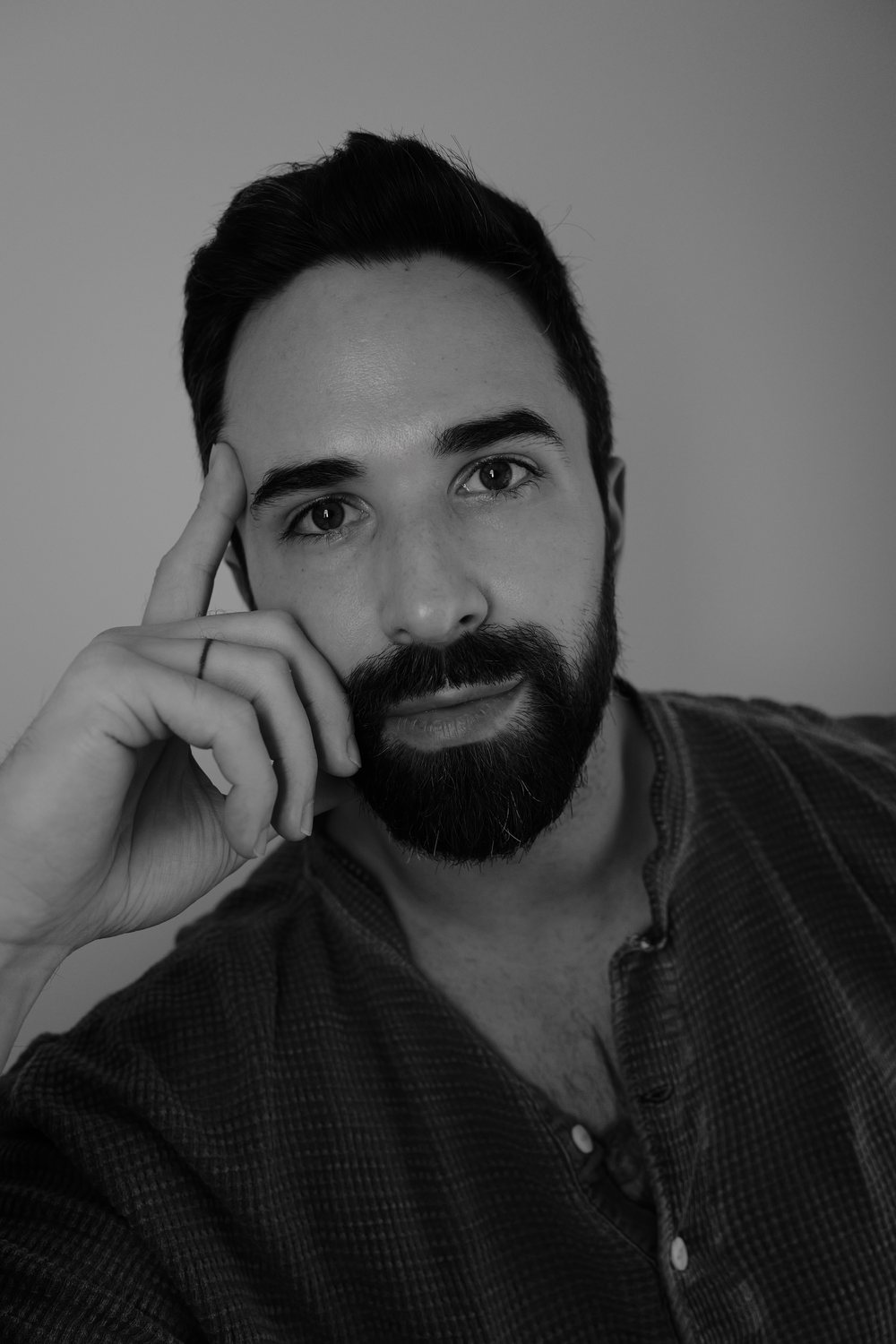 Portrait of Joe Svetlosak, resting his head on his hand